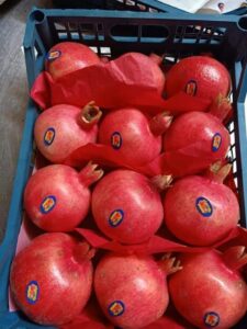 Fresh Egyptian pomegranates packed in a blue export crate by Gaara Export